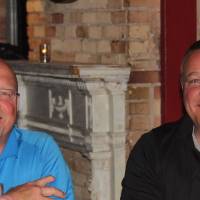 2 men smiling at camera